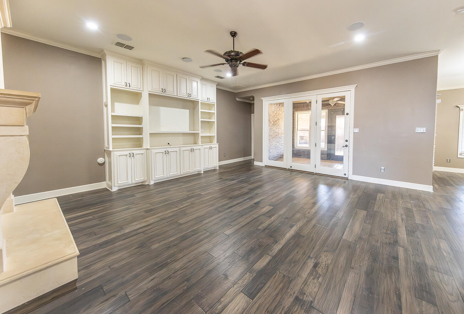 11302 Juneau Avenue Lubbock, TX 79424 - Photo 8 of 49 a view of an empty room with a window and wooden floor