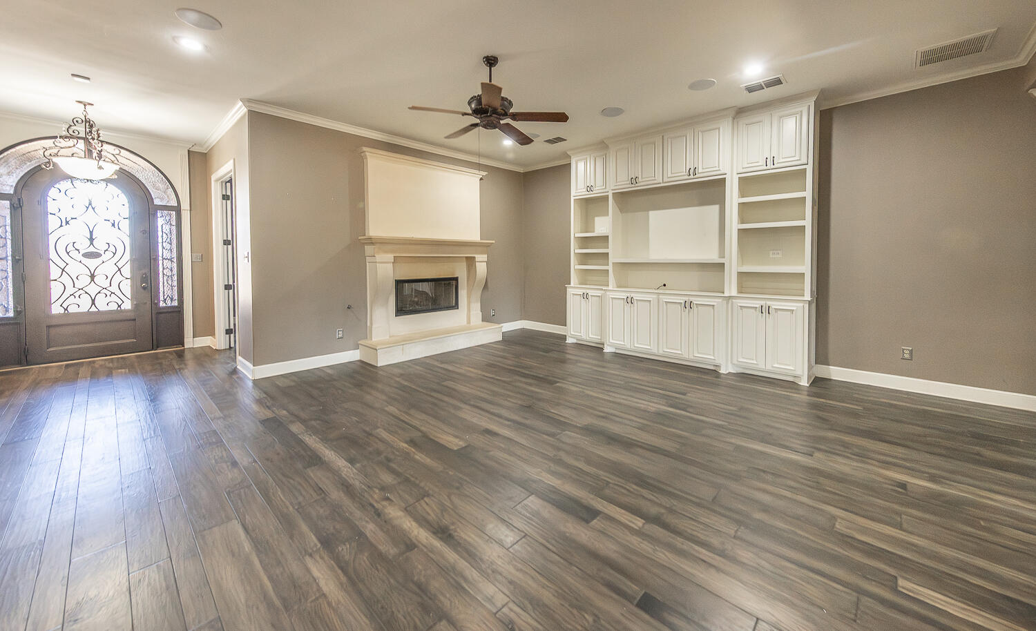 11302 Juneau Avenue Lubbock, TX 79424 - Photo 10 of 49 an empty room with wooden floor chandelier and windows