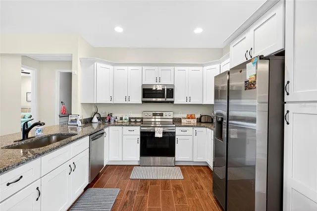 a kitchen with a sink stainless steel appliances and cabinets