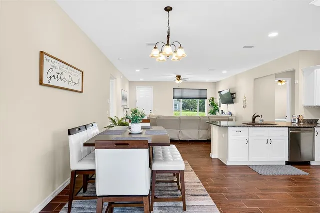 a view of a dining room with furniture and a chandelier