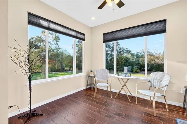 a work room with wooden floor and a large window