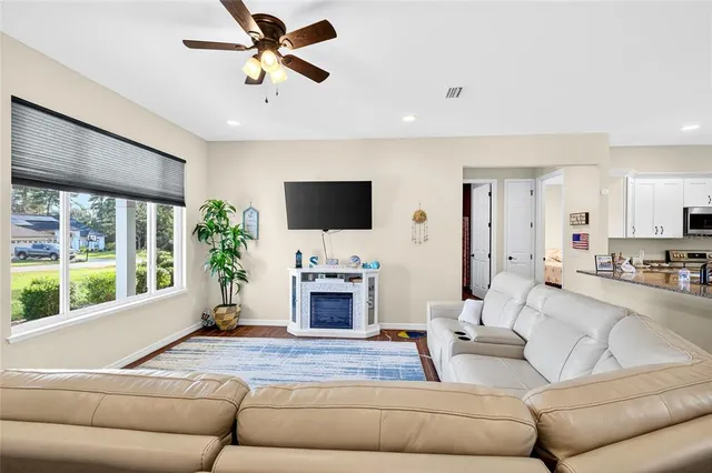 a living room with furniture fireplace and a flat screen tv
