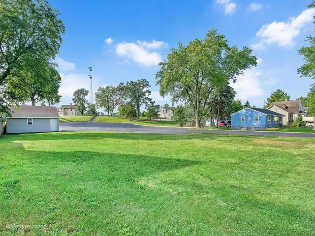 a view of outdoor space with garden and trees