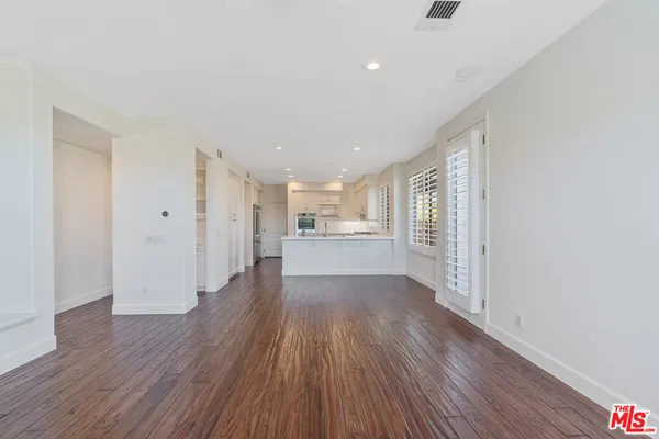 a view of a kitchen with wooden floor