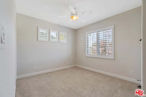 a bathroom with a granite countertop sink a toilet and shower