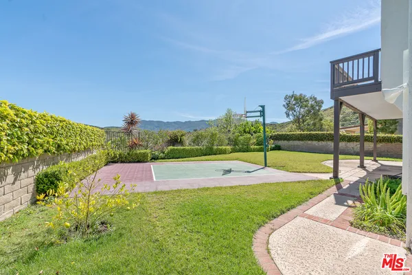 a view of a house with pool and a yard