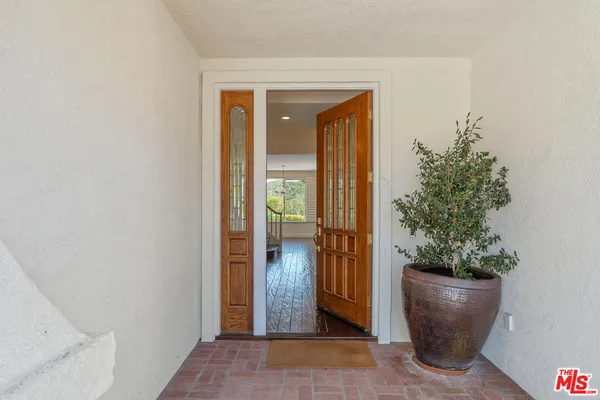 a view of an entryway and wooden floor