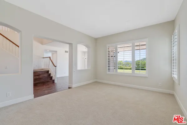 a view of a livingroom with a hard wood floor and a window