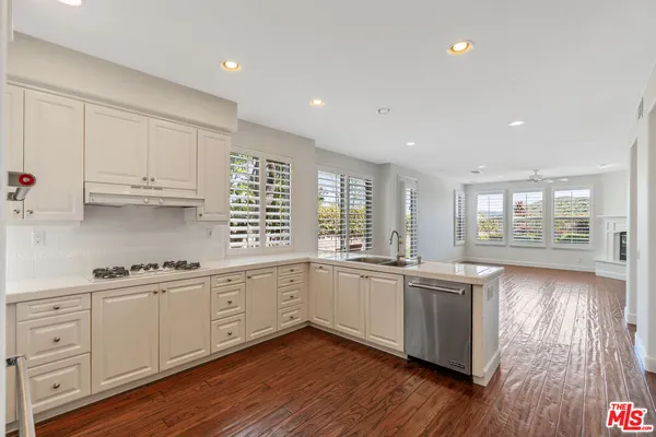 a kitchen with sink and cabinets
