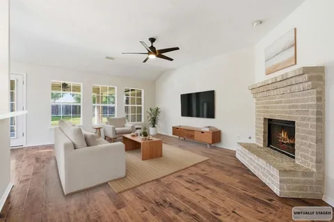 a living room with furniture and a fireplace