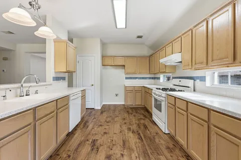 a kitchen with stainless steel appliances granite countertop a sink and cabinets