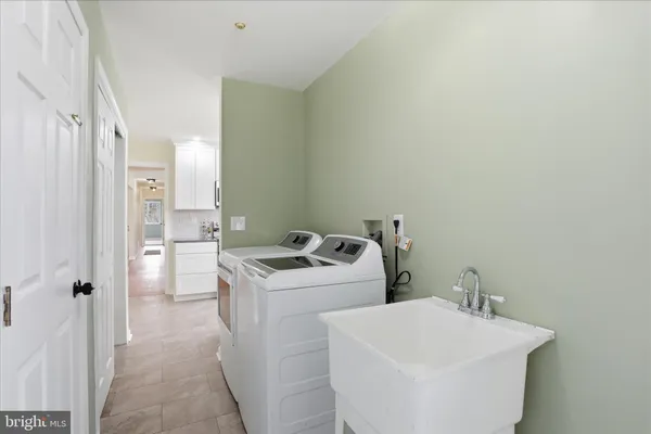 a spacious bathroom with a double vanity sink and a mirror