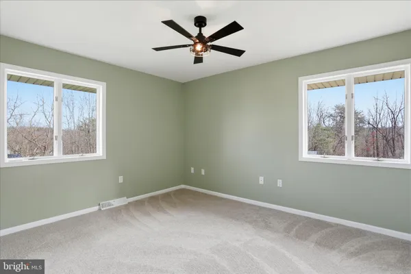 a view of backyard of house with green space