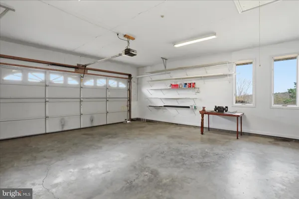 a front view of a house with a yard and potted plants