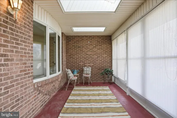 a view of a hallway with wooden floor and dining room