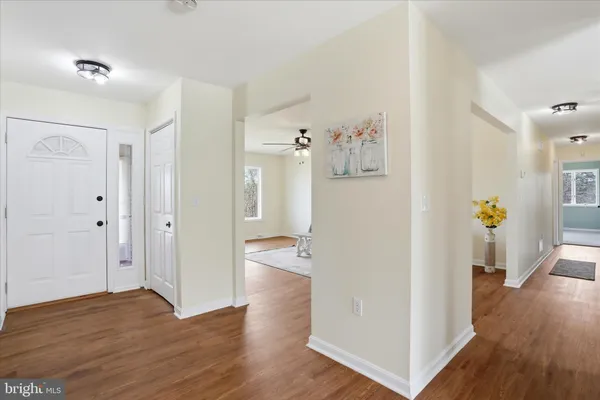 a view of a livingroom with a ceiling fan and window