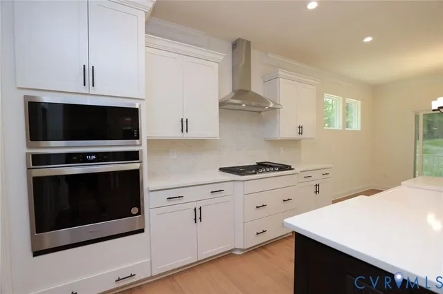 a kitchen with stainless steel appliances a stove microwave and cabinets