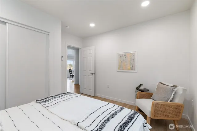 a spacious bedroom with a bed and a potted plant