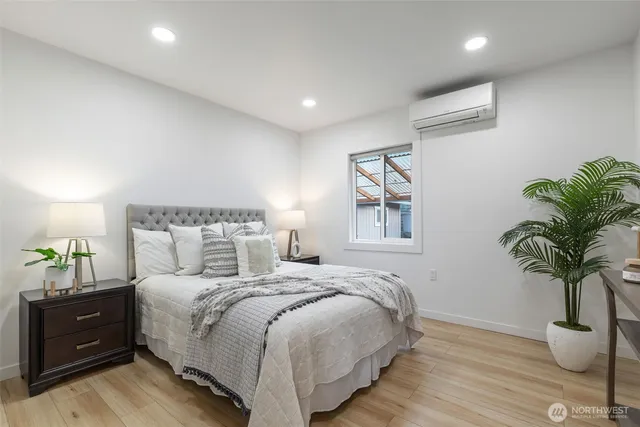 a bedroom with a bed and a potted plant