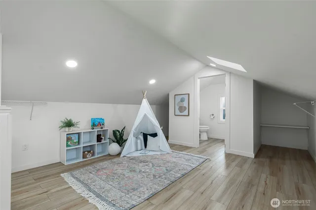 a view of a room with wooden floor