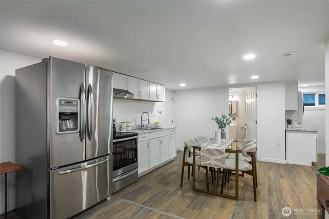 a bedroom with a bed and painting on the wall