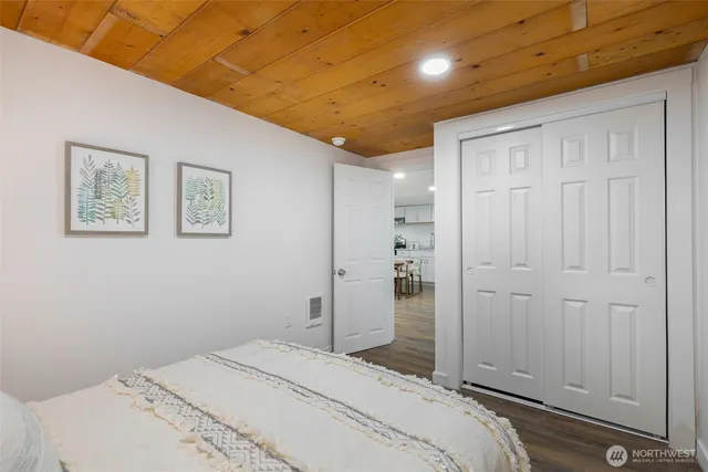 a bedroom with a bed and a painting on the wall