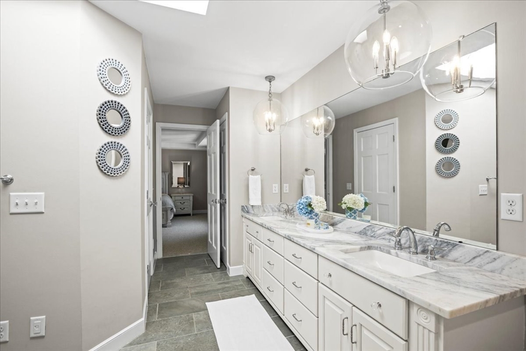 9 Auburn Road Millbury, MA 01527 - Photo 23 of 42 a spacious bathroom with a granite countertop sink and a mirror