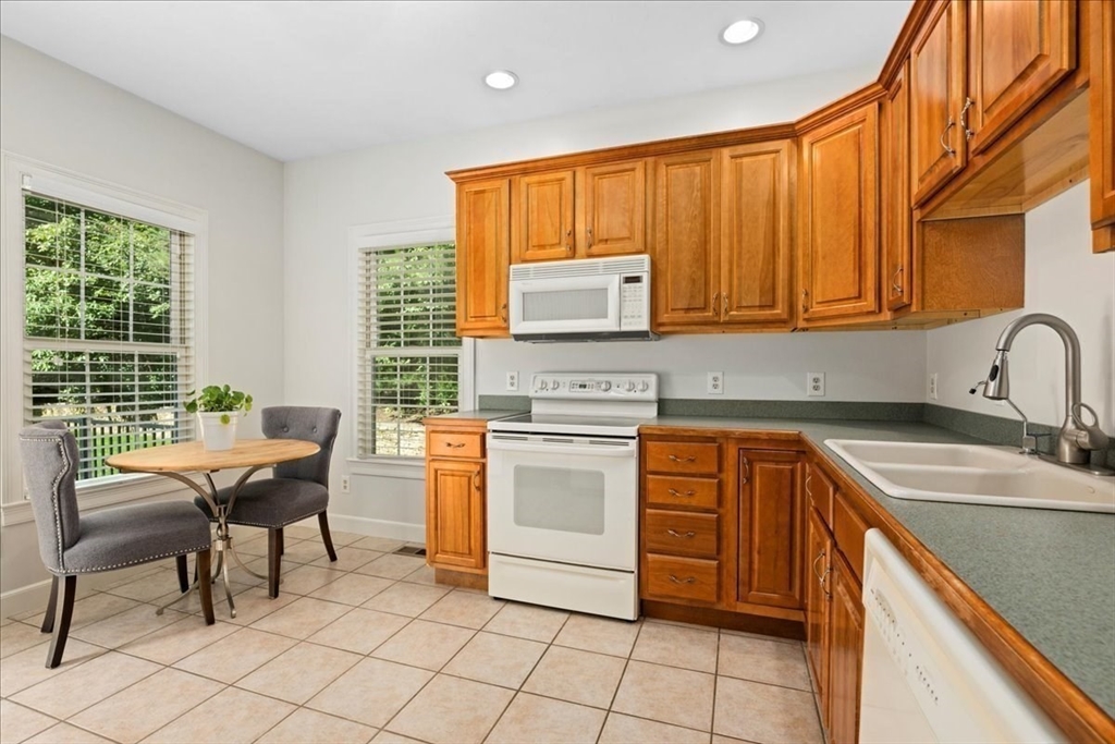 9 Auburn Road Millbury, MA 01527 - Photo 25 of 42 a kitchen with stainless steel appliances granite countertop a stove a sink and a microwave