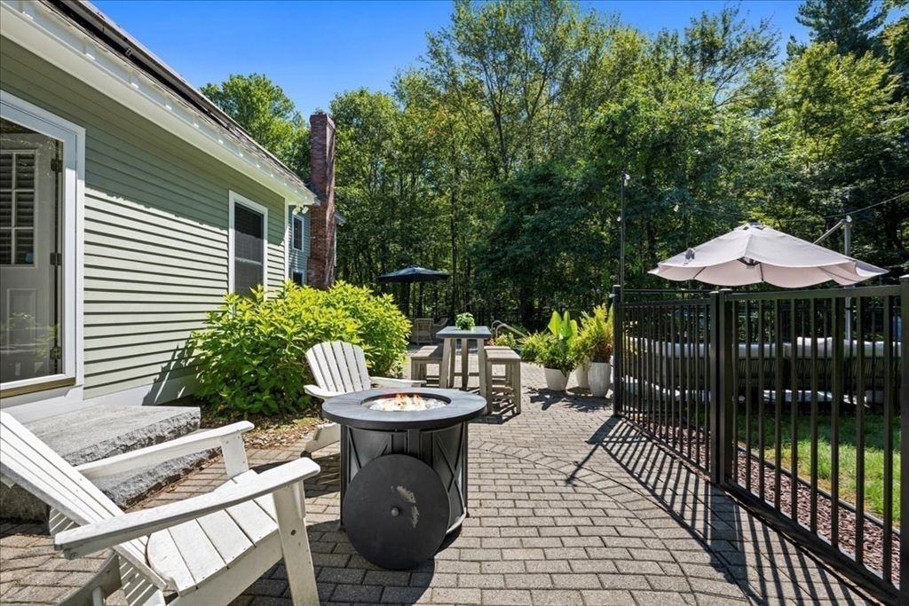 9 Auburn Road Millbury, MA 01527 - Photo 33 of 42 a view of a patio with table and chairs potted plants with wooden fence