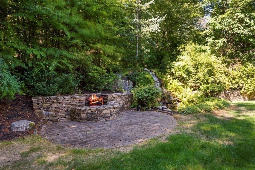 9 Auburn Road Millbury, MA 01527 - Photo 38 of 42 a view of a backyard with fountain plants and large tree