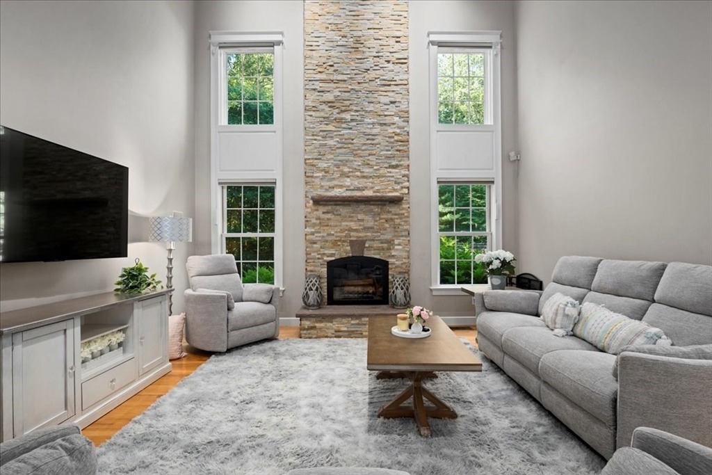 9 Auburn Road Millbury, MA 01527 - Photo 4 of 42 a living room with furniture a flat screen tv and a fireplace