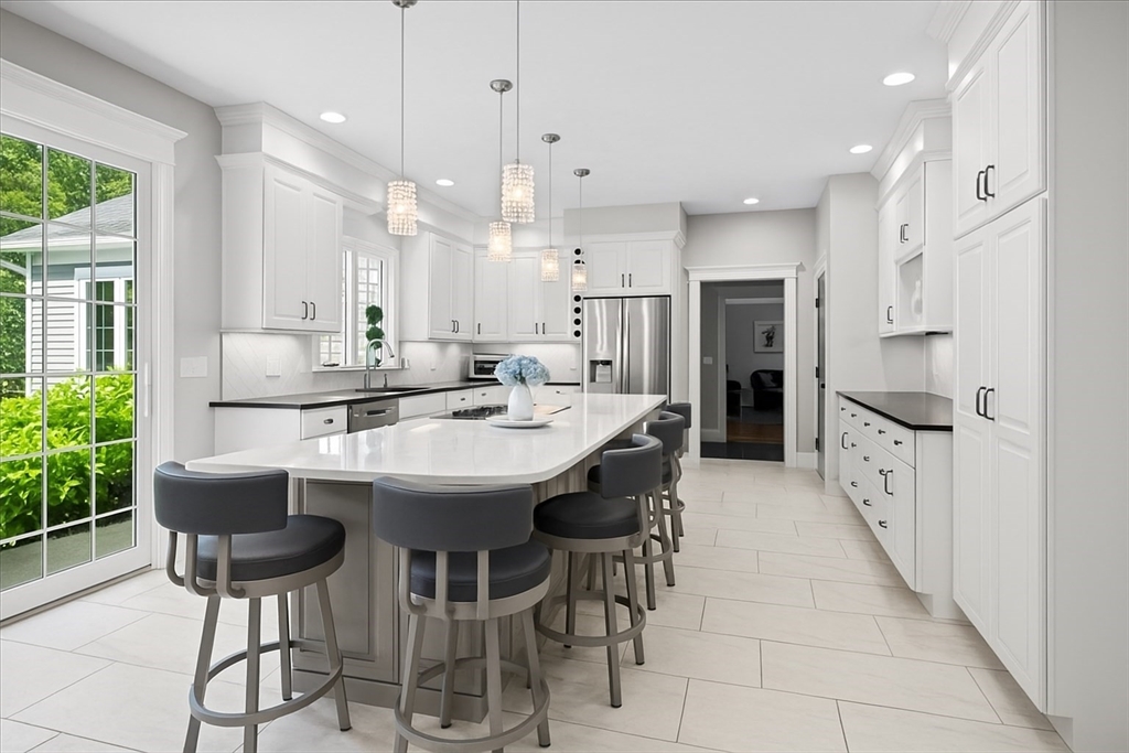 9 Auburn Road Millbury, MA 01527 - Photo 7 of 42 a kitchen with stainless steel appliances kitchen island granite countertop a dining table chairs and white cabinets