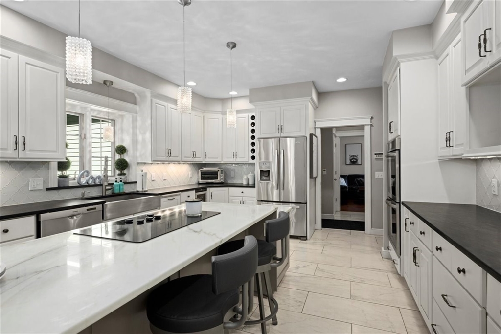 9 Auburn Road Millbury, MA 01527 - Photo 8 of 42 a kitchen with stainless steel appliances a sink a stove a refrigerator and cabinets