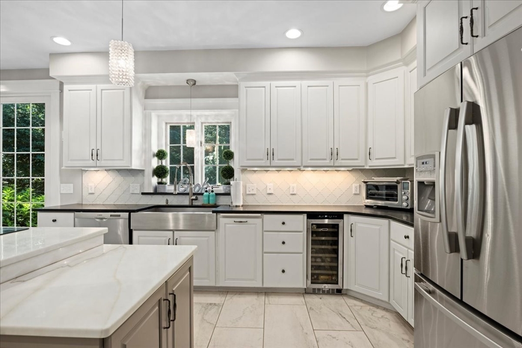 9 Auburn Road Millbury, MA 01527 - Photo 10 of 42 a kitchen with stainless steel appliances granite countertop a sink and dishwasher a refrigerator with white cabinets
