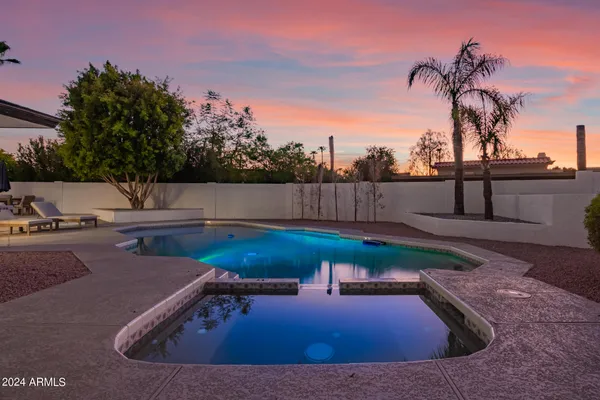 a view of a house with a backyard and a patio