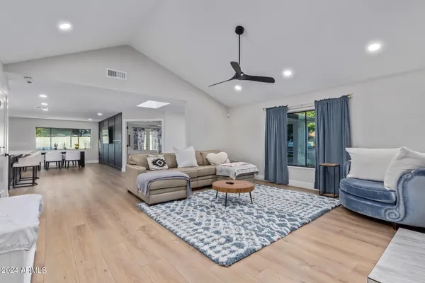 a spacious bedroom with a bed and a flat screen tv