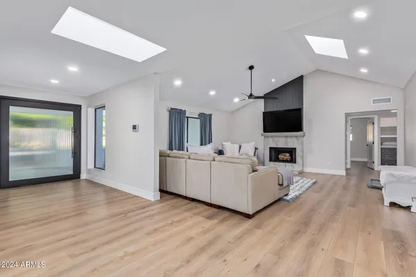 a kitchen with stainless steel appliances kitchen island granite countertop a dining table chairs and kitchen view