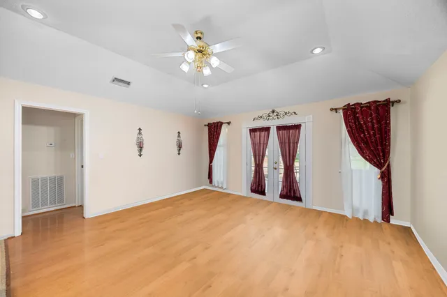 a view of a room with a ceiling fan and a window