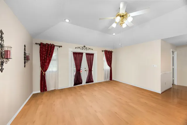 a view of a room with window and ceiling fan