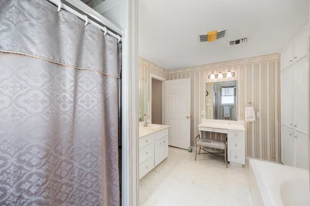 a bedroom that has a bed and a chandelier