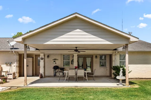 a front view of a house with a yard table and chairs