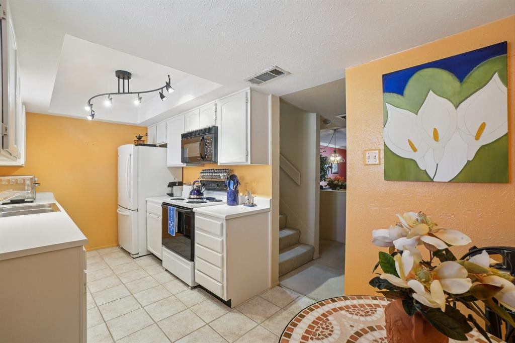 4569 North O'Connor Road, Unit 1319 Irving, TX 75062 - Photo 12 of 40 a kitchen with a sink appliances and cabinets