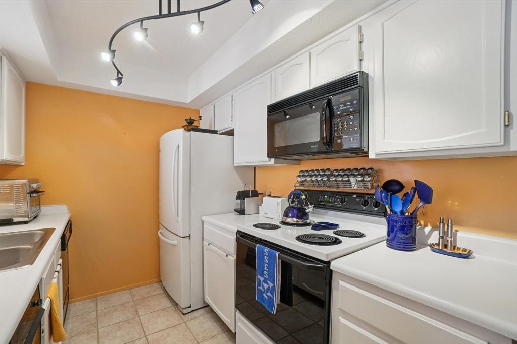 4569 North O'Connor Road, Unit 1319 Irving, TX 75062 - Photo 15 of 40 a kitchen with stainless steel appliances a stove microwave and refrigerator