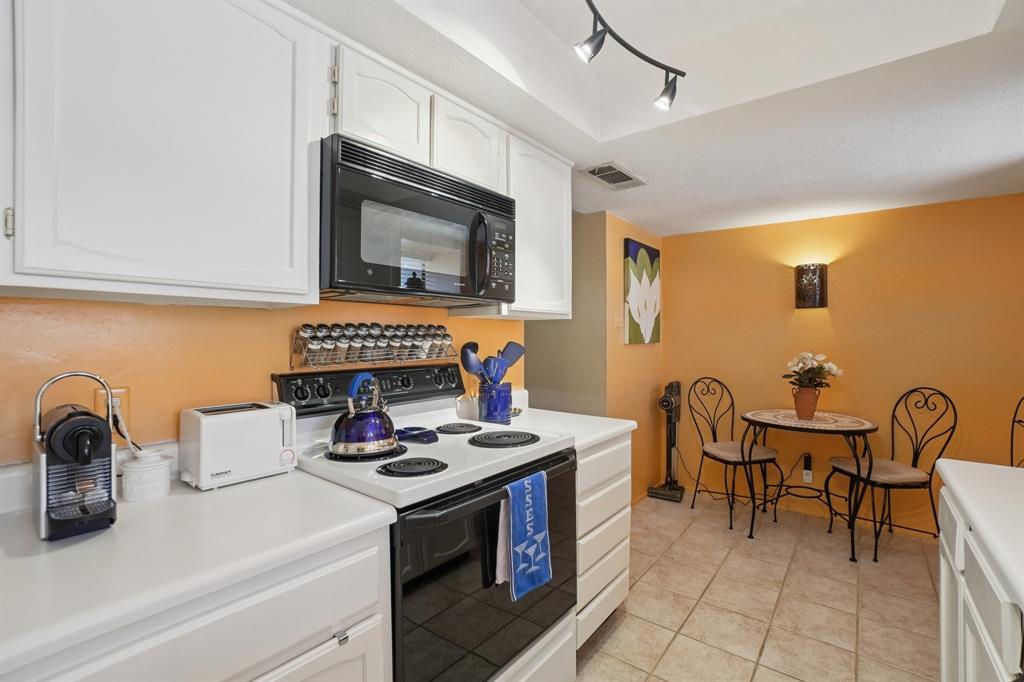 4569 North O'Connor Road, Unit 1319 Irving, TX 75062 - Photo 16 of 40 a kitchen with a stove and a microwave