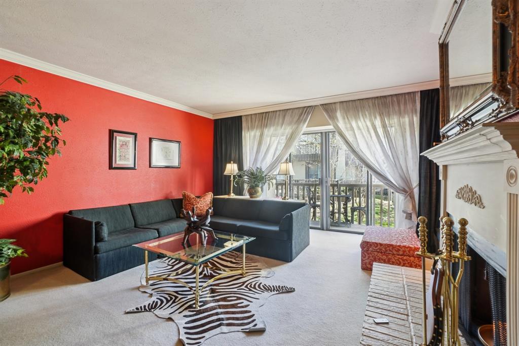 4569 North O'Connor Road, Unit 1319 Irving, TX 75062 - Photo 4 of 40 a living room with furniture a flat screen tv and a floor to ceiling window