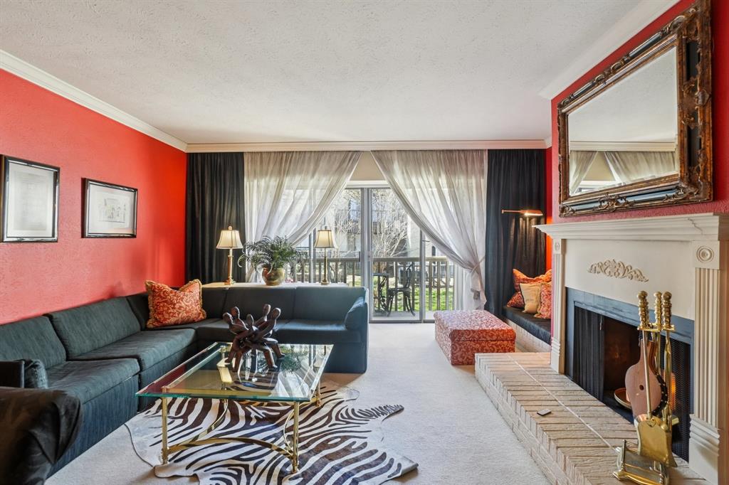 4569 North O'Connor Road, Unit 1319 Irving, TX 75062 - Photo 5 of 40 a living room with furniture a fireplace and a large window