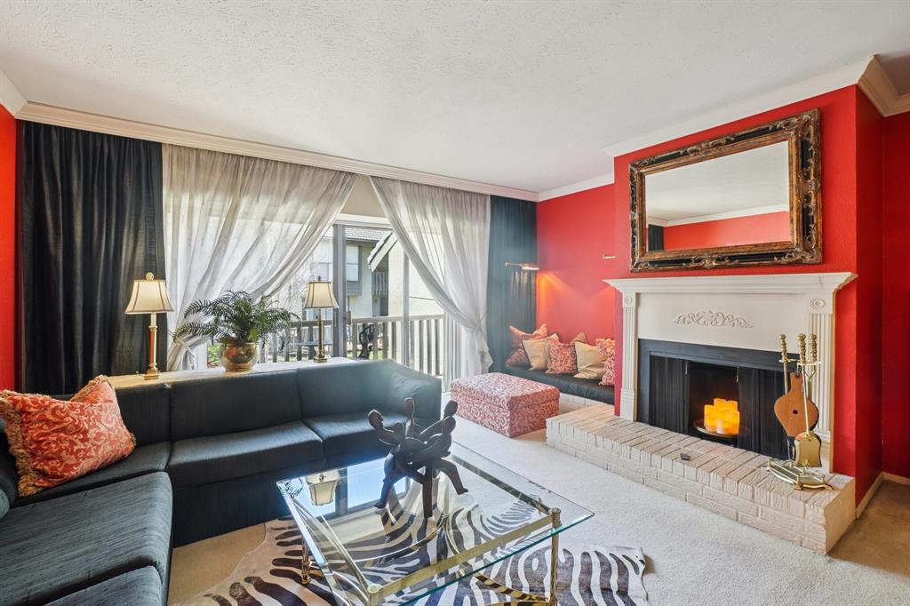 4569 North O'Connor Road, Unit 1319 Irving, TX 75062 - Photo 6 of 40 a living room with furniture a large window and a fireplace