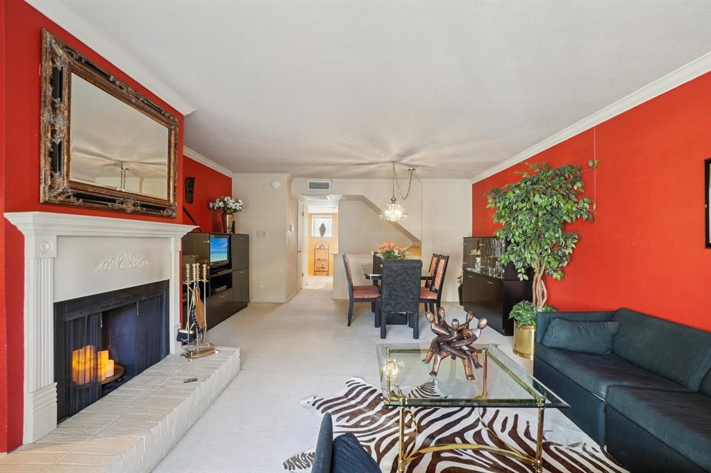 4569 North O'Connor Road, Unit 1319 Irving, TX 75062 - Photo 7 of 40 a living room with furniture a fireplace and a flat screen tv