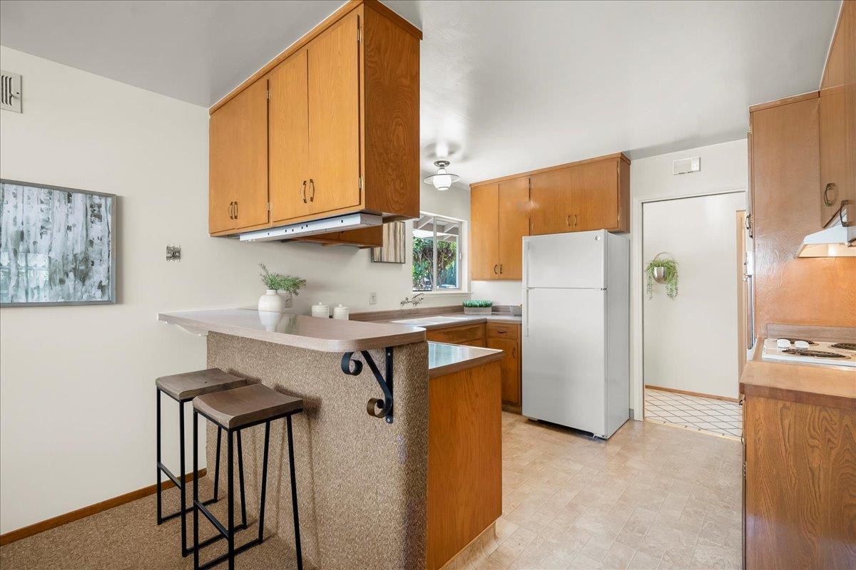 5371 Clovercrest Drive San Jose, CA 95118 - Photo 12 of 29 a kitchen with stainless steel appliances a refrigerator a sink and white cabinets