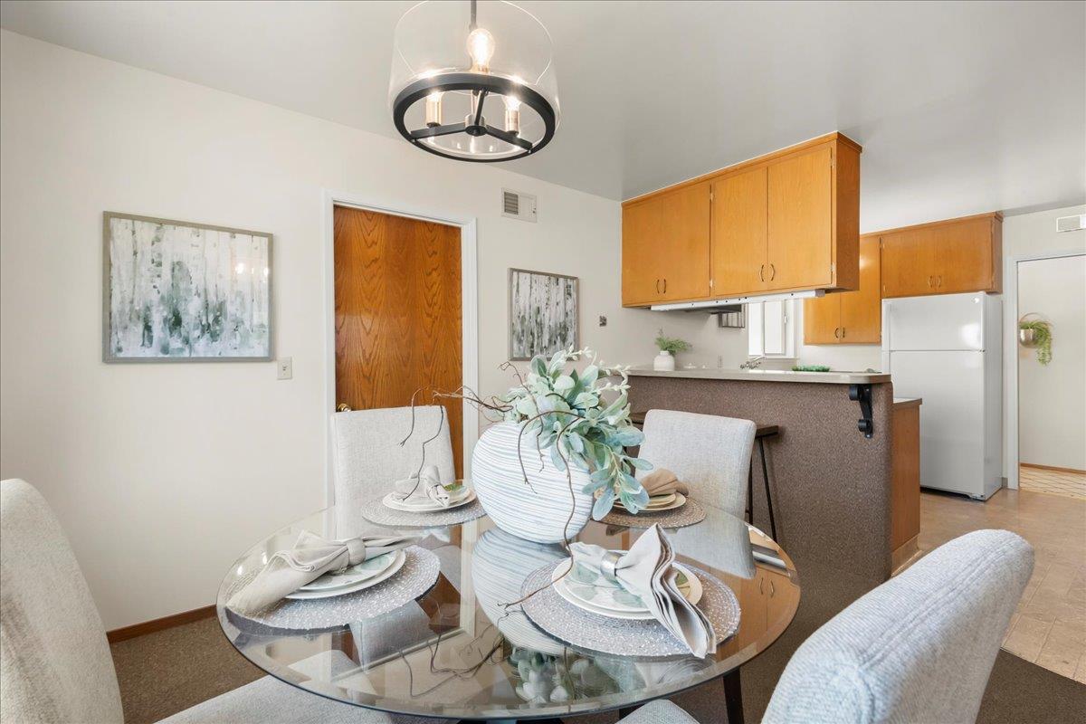 5371 Clovercrest Drive San Jose, CA 95118 - Photo 10 of 29 a view of a dining room with furniture a chandelier and wooden floor